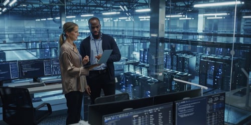 Business team reviewing IT systems and network information during a managed IT services planning meeting.