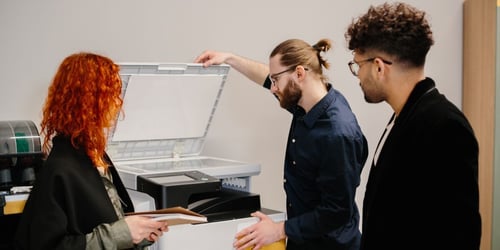 Modern office copier and printer equipment in a business workspace