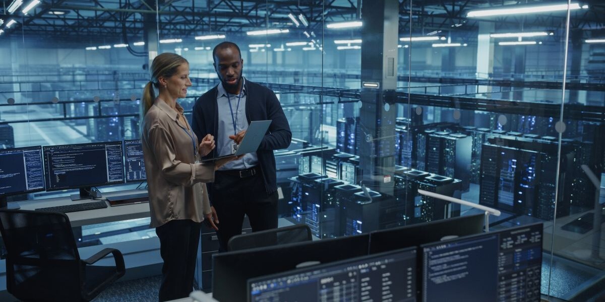 Business team reviewing IT systems and network information during a managed IT services planning meeting.