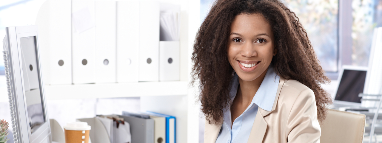 woman dressed in business attire smiling at camera