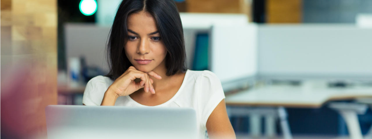 Business woman staring intently at laptop