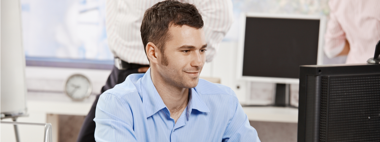 Worker at desk looking at computer